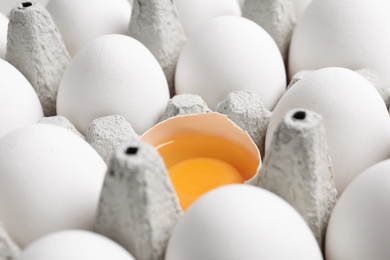 Photo of Many fresh raw chicken eggs in cartons as background, closeup