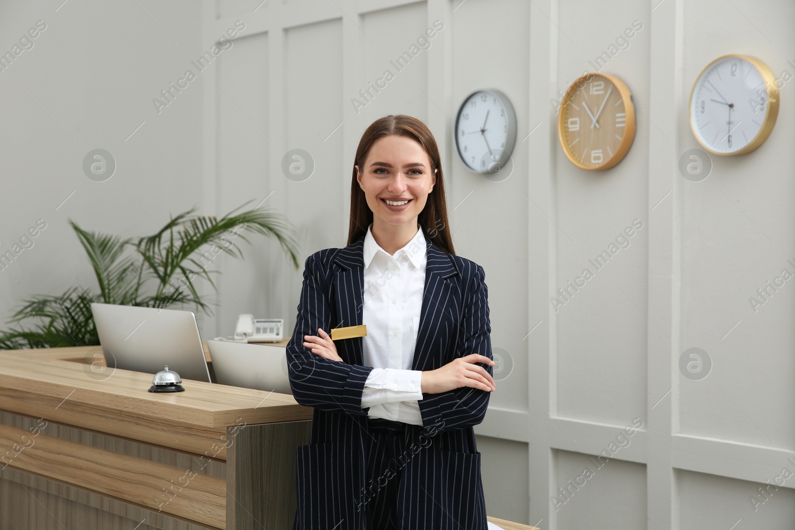 Photo of Portrait of beautiful receptionist near counter in hotel