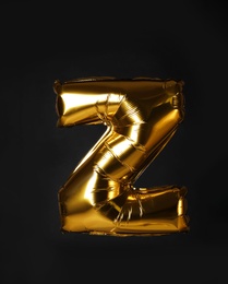 Golden letter Z balloon on black background