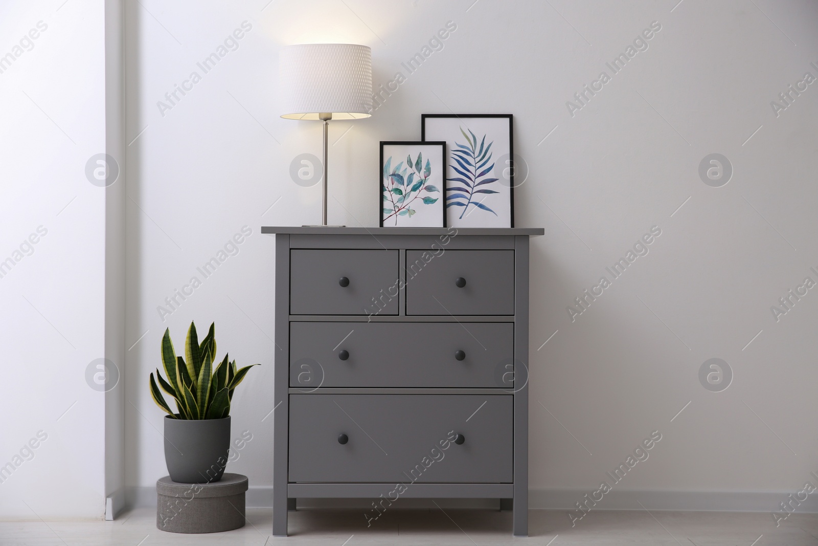 Photo of Grey chest of drawers in stylish room interior