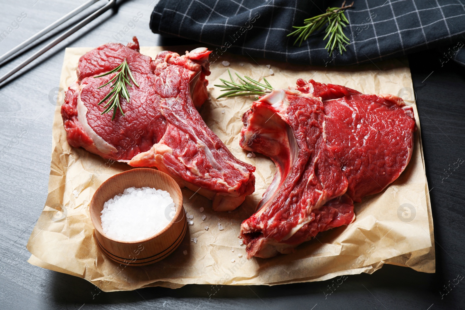 Photo of Composition with fresh raw meat on black table