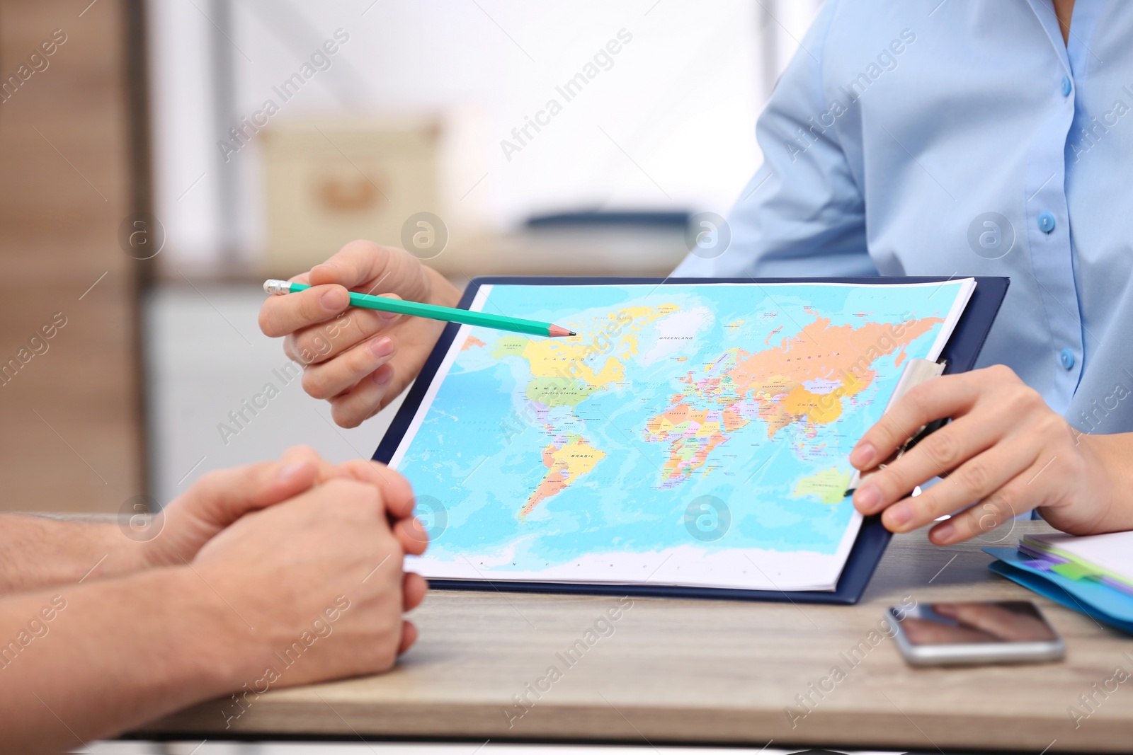 Photo of Female manager consulting client in travel agency, closeup