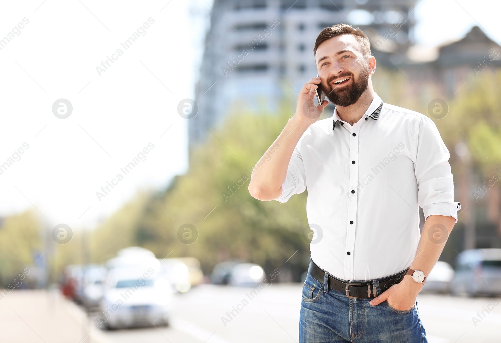 Photo of Portrait of young man talking on phone outdoors