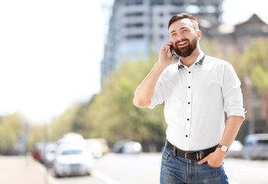 Photo of Portrait of young man talking on phone outdoors