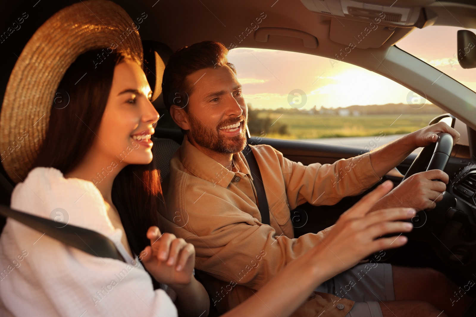 Photo of Happy couple enjoying trip together by car