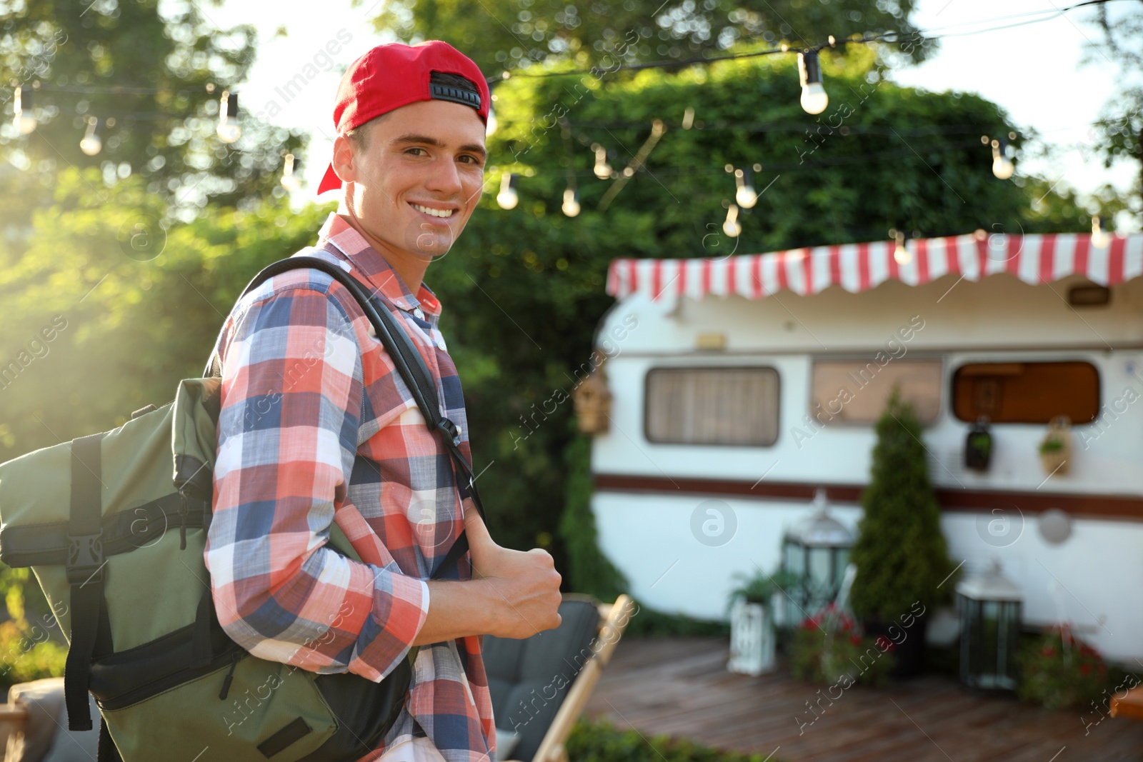 Photo of Young traveler with backpack outdoors. Summer trip