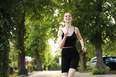 Photo of Teenage girl running outdoors in morning, space for text