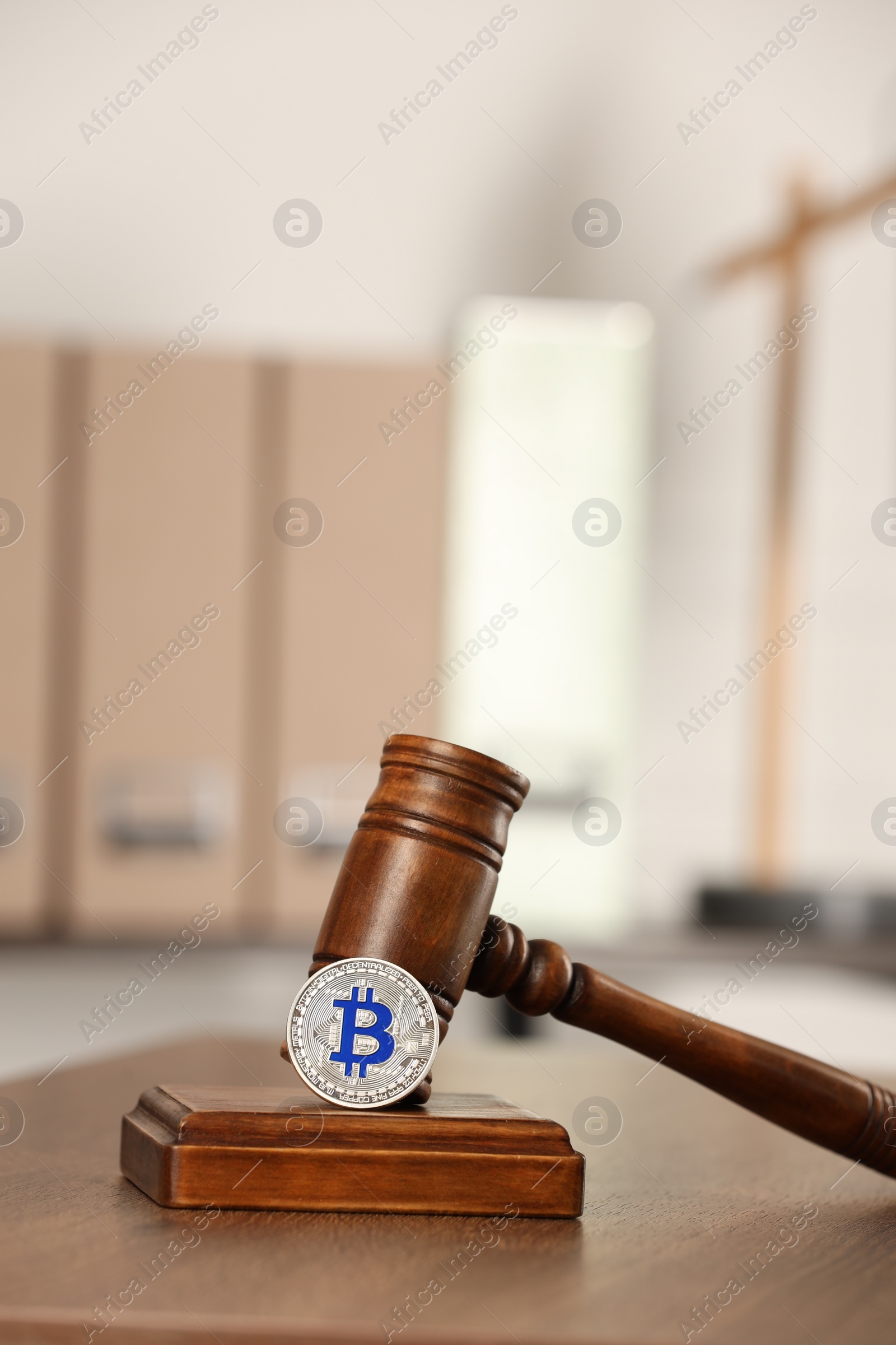 Photo of Law concept. Gavel and bitcoin on wooden table, space for text