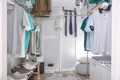 Modern dressing room with different stylish clothes and accessories