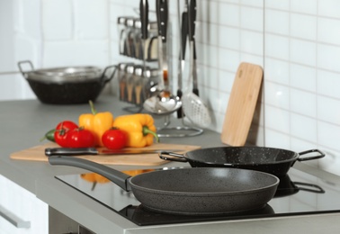 Clean cookware and utensils on table in kitchen