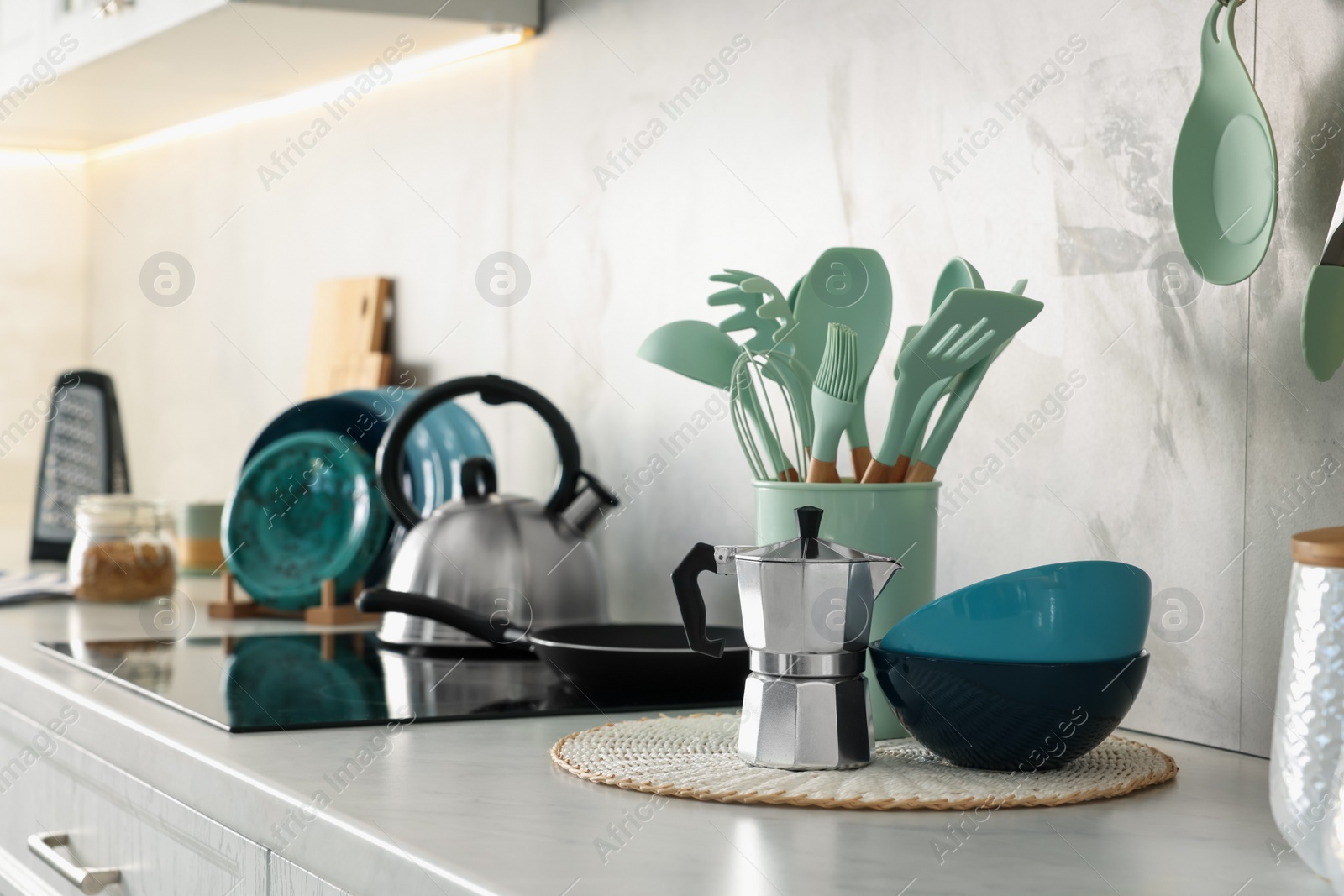 Photo of Set of different utensils and dishes on countertop in kitchen