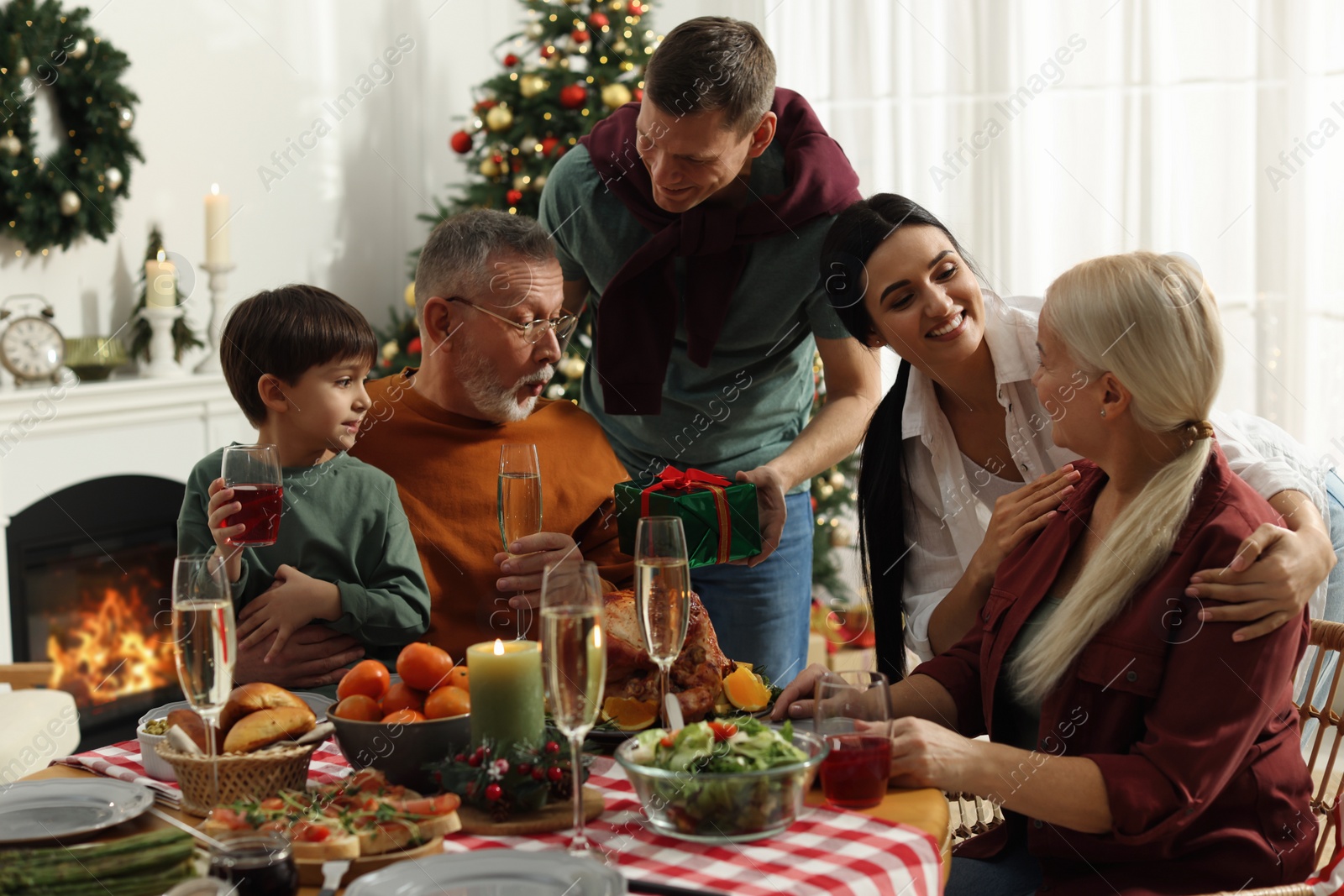 Photo of Happy family enjoying festive dinner at home. Christmas celebration