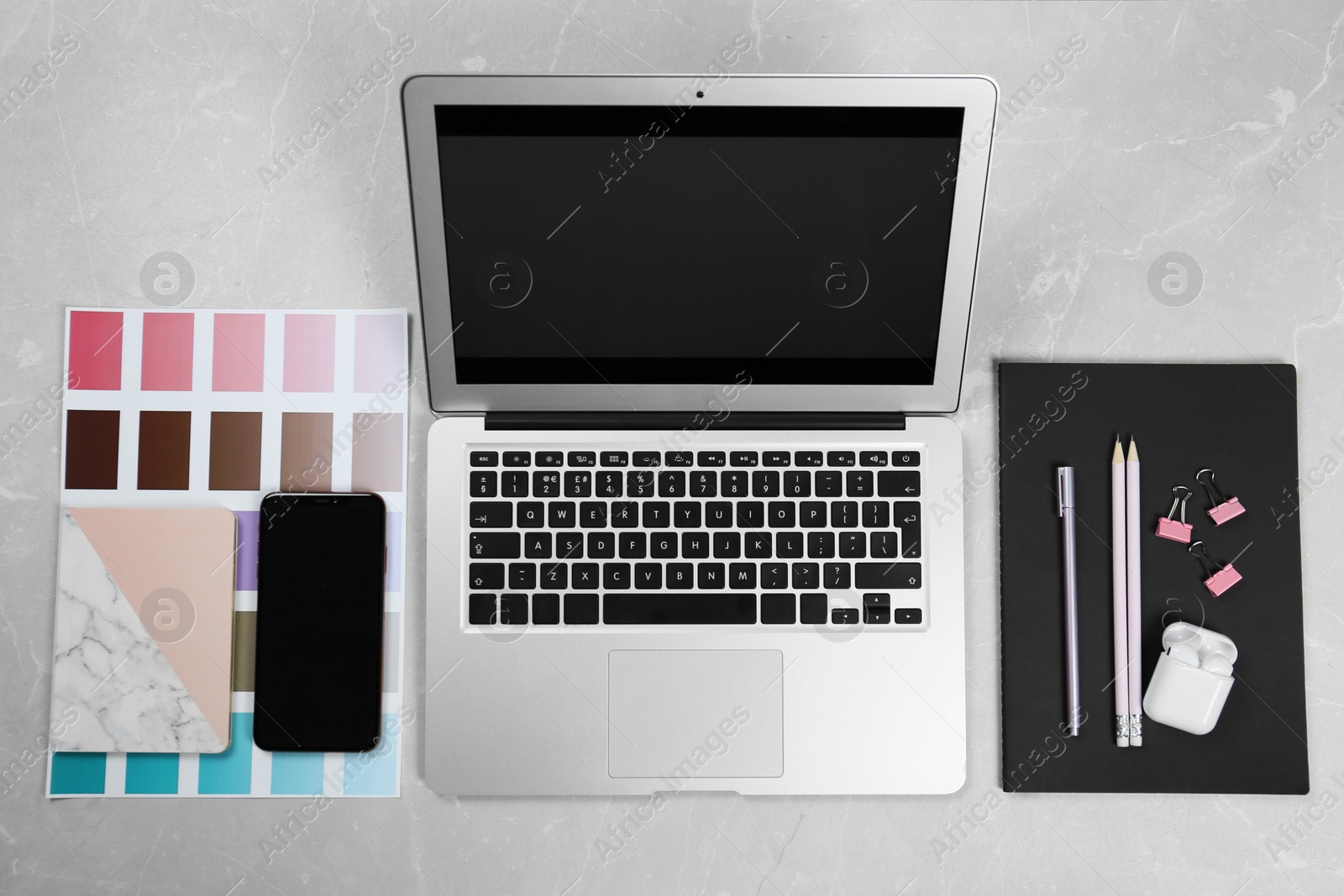 Photo of Flat lay composition with laptop on marble table. Designer workplace