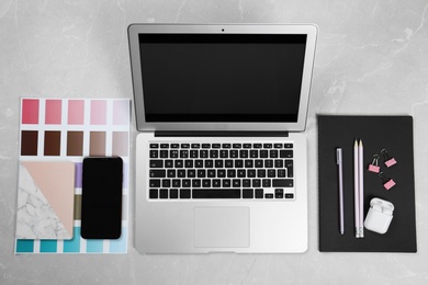 Photo of Flat lay composition with laptop on marble table. Designer workplace