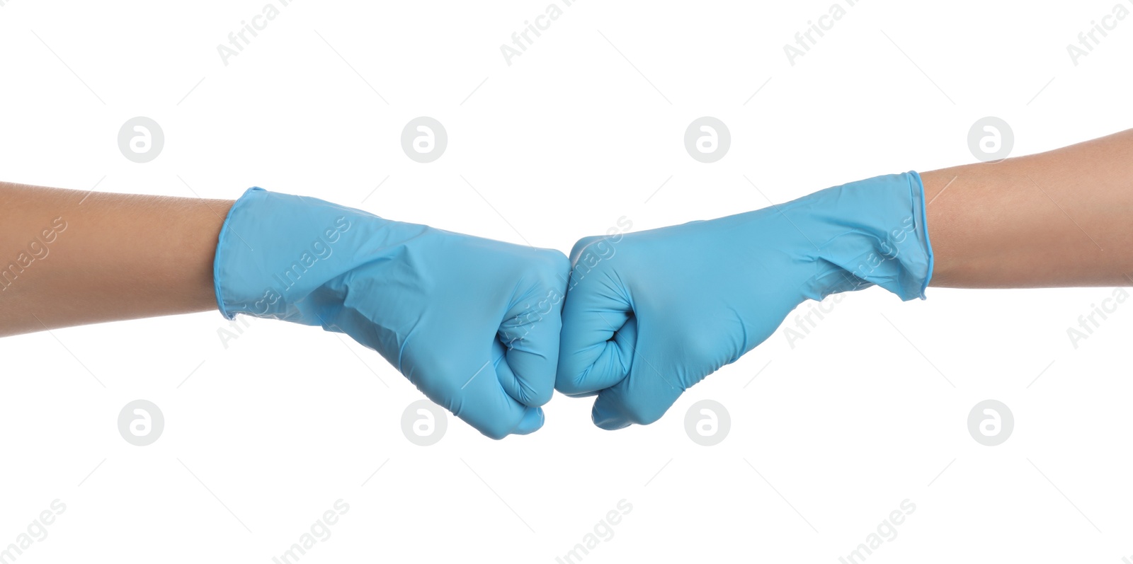Photo of Doctors in medical gloves making fist bump on white background, closeup