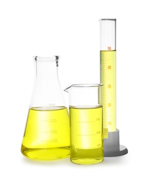 Different laboratory glassware with yellow liquid isolated on white