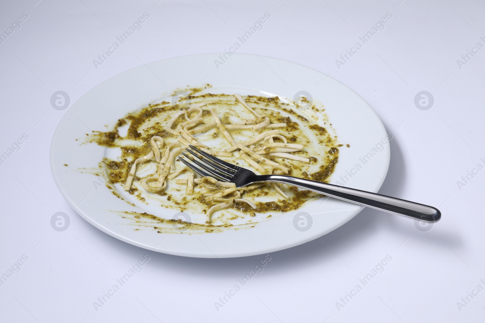 Photo of Dirty plate and fork on white background