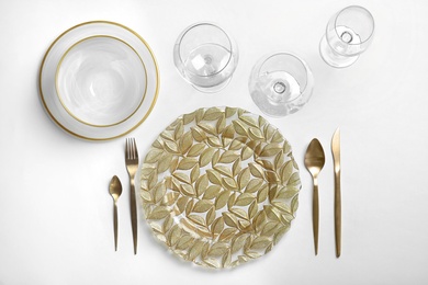 Elegant table setting on light background, top view