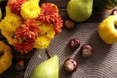 Photo of Autumn flat lay composition with beautiful chrysanthemum flowers and fruits on wooden table