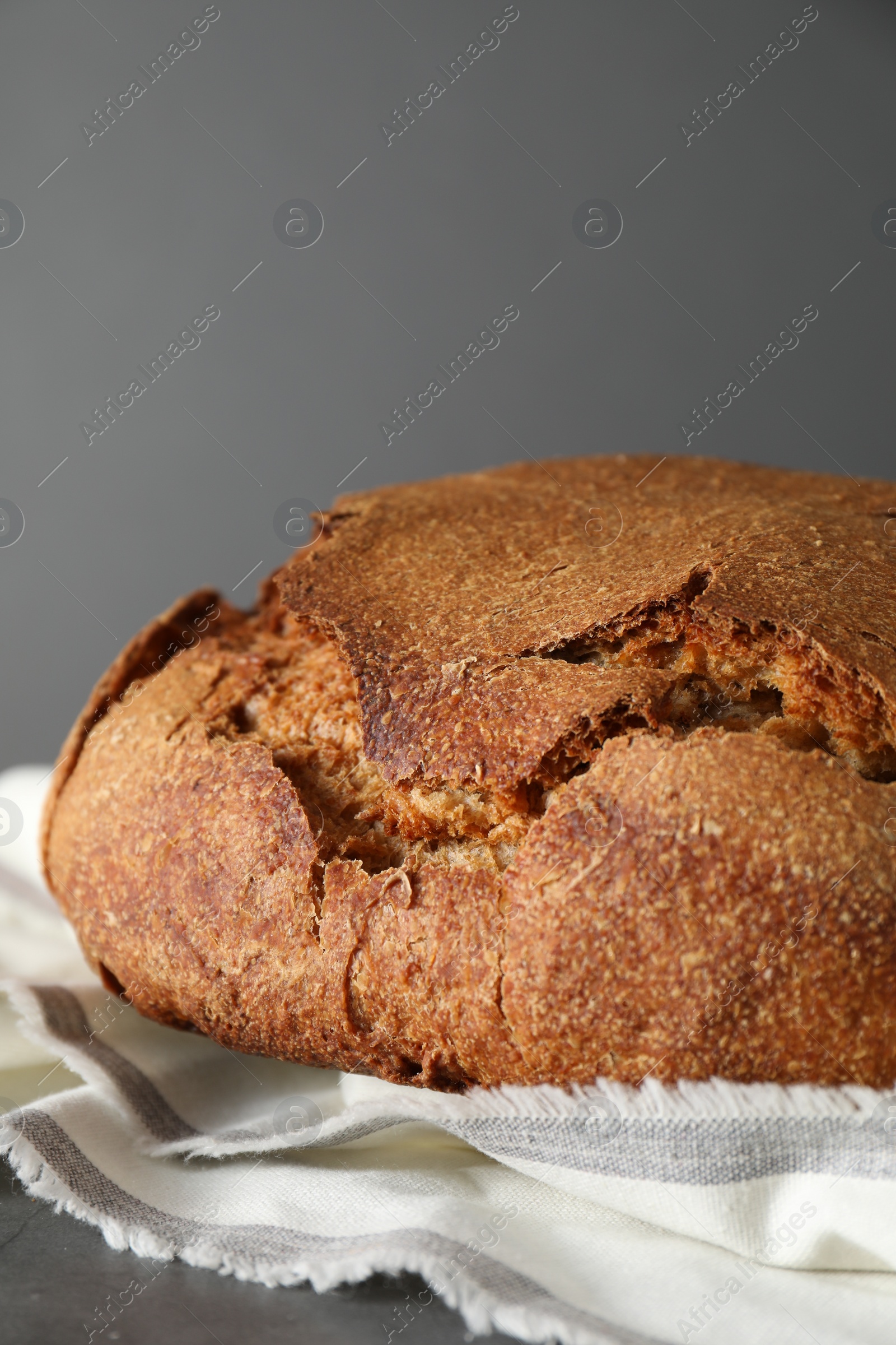 Photo of Freshly baked sourdough bread on table against grey background