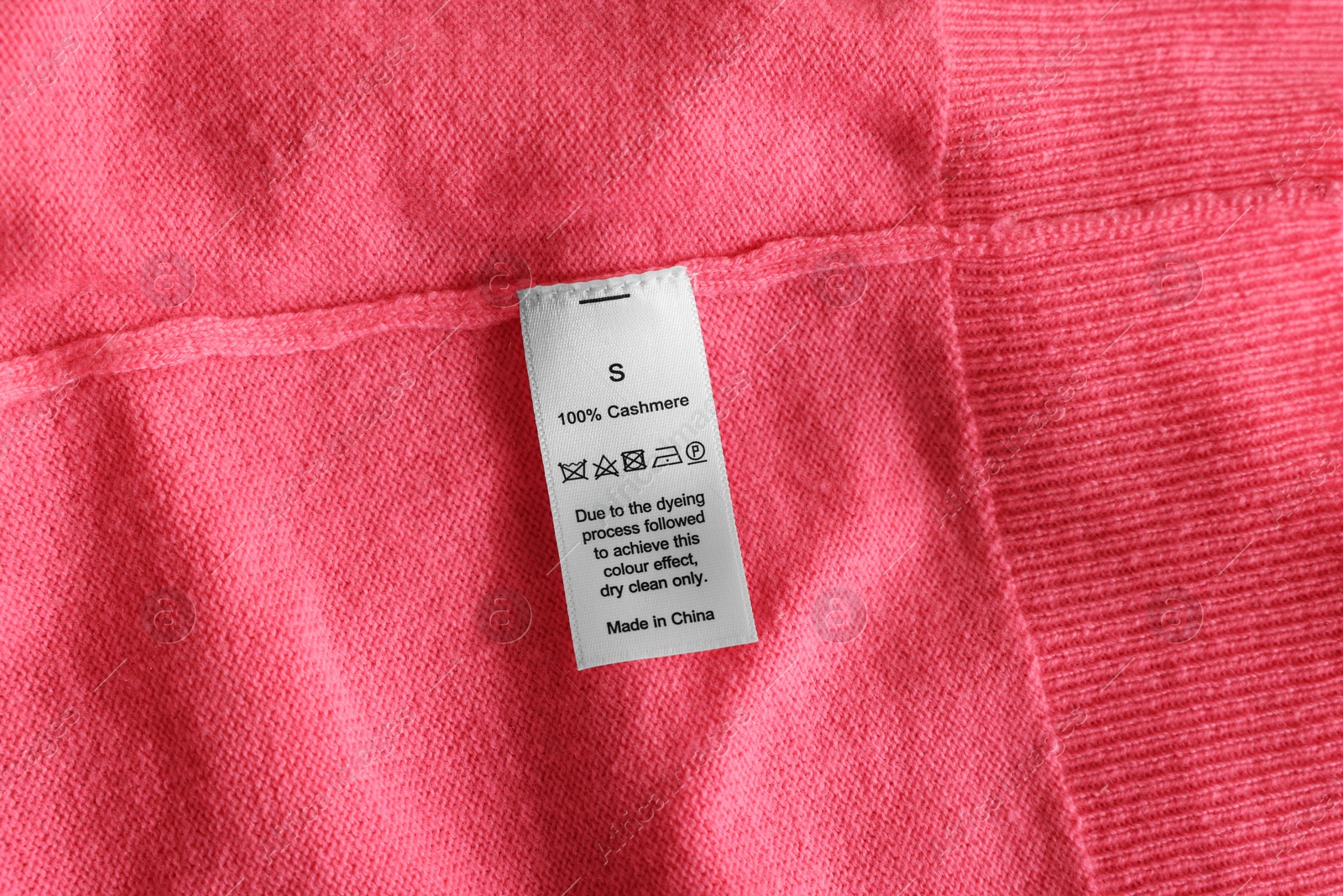 Photo of Clothing label on coral garment, top view