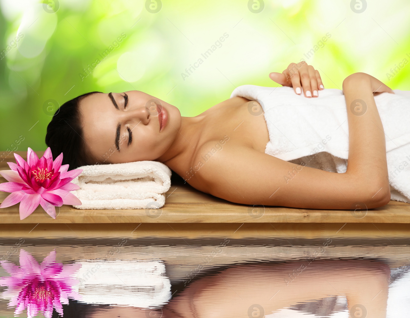 Image of Young woman lying on wooden bench. Spa treatment