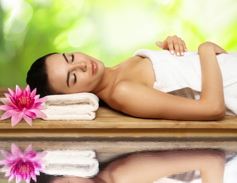 Image of Young woman lying on wooden bench. Spa treatment