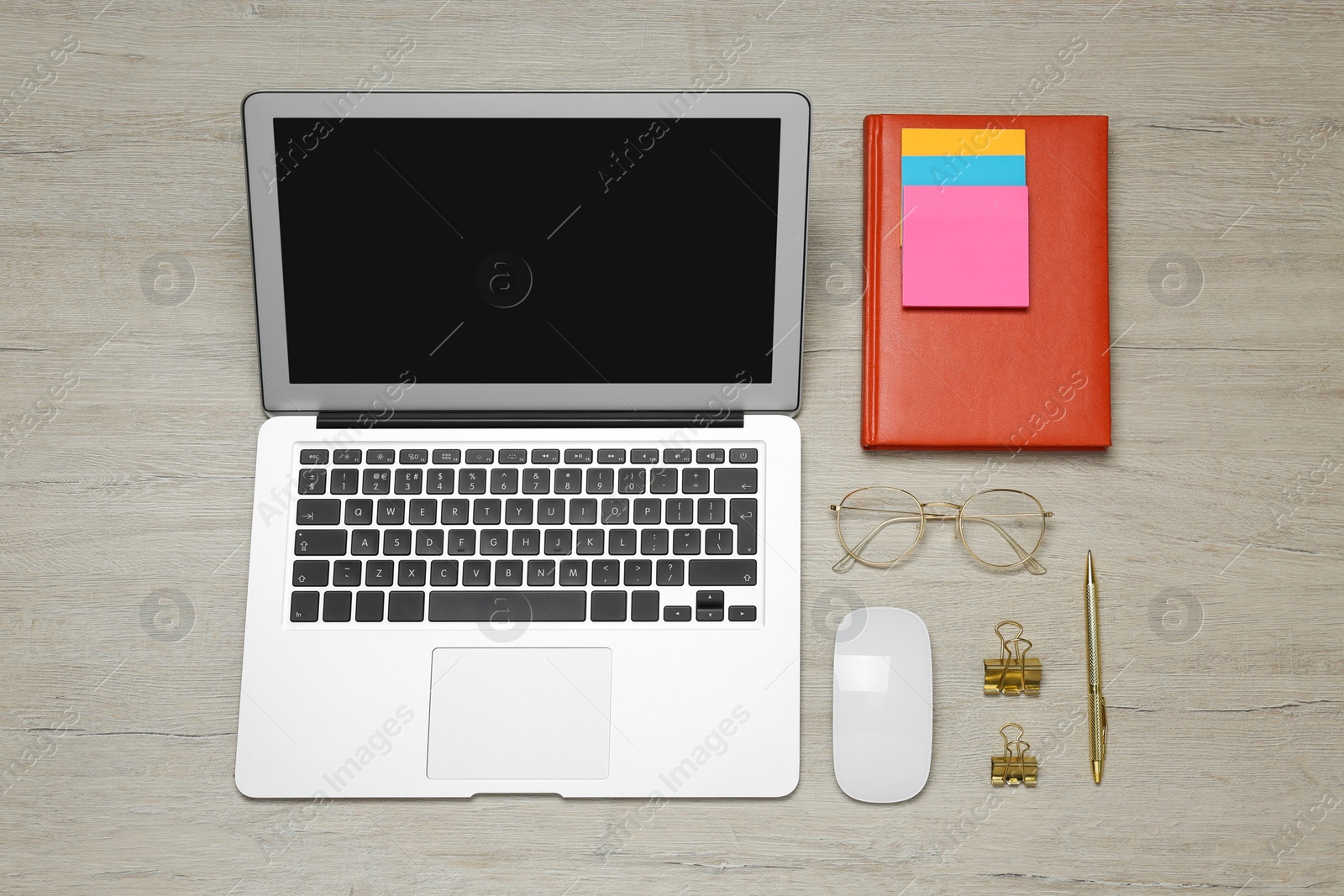 Photo of Modern laptop, glasses and office stationery on white wooden table, flat lay. Distance learning