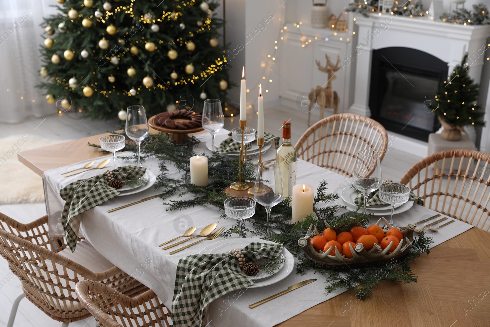 Photo of Christmas table setting with festive decor and dishware in living room