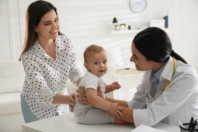 Photo of Mother with her cute baby visiting pediatrician in clinic