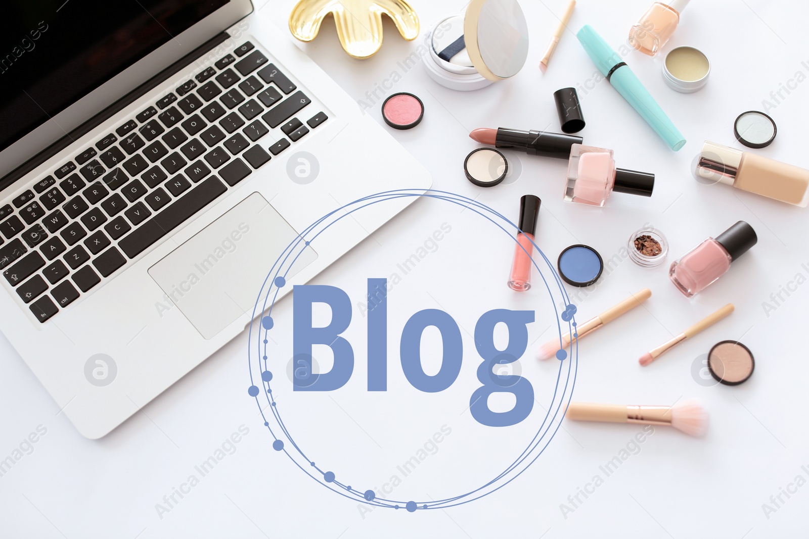 Image of Blogger's workplace with laptop and makeup products on white background, flat lay