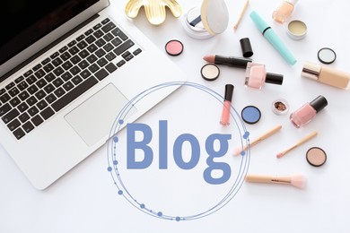 Blogger's workplace with laptop and makeup products on white background, flat lay