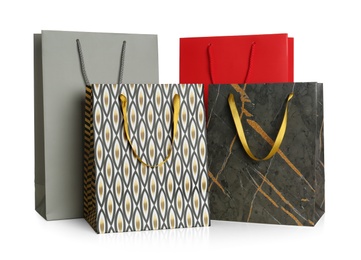 Photo of Stylish gift paper bags isolated on white