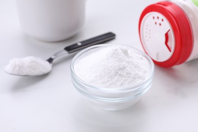 Photo of Sweet fructose powder and cup of drink on white marble table