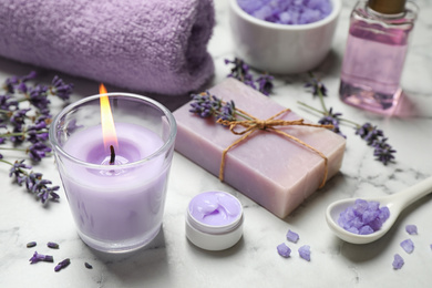 Photo of Cosmetic products and lavender flowers on white marble table
