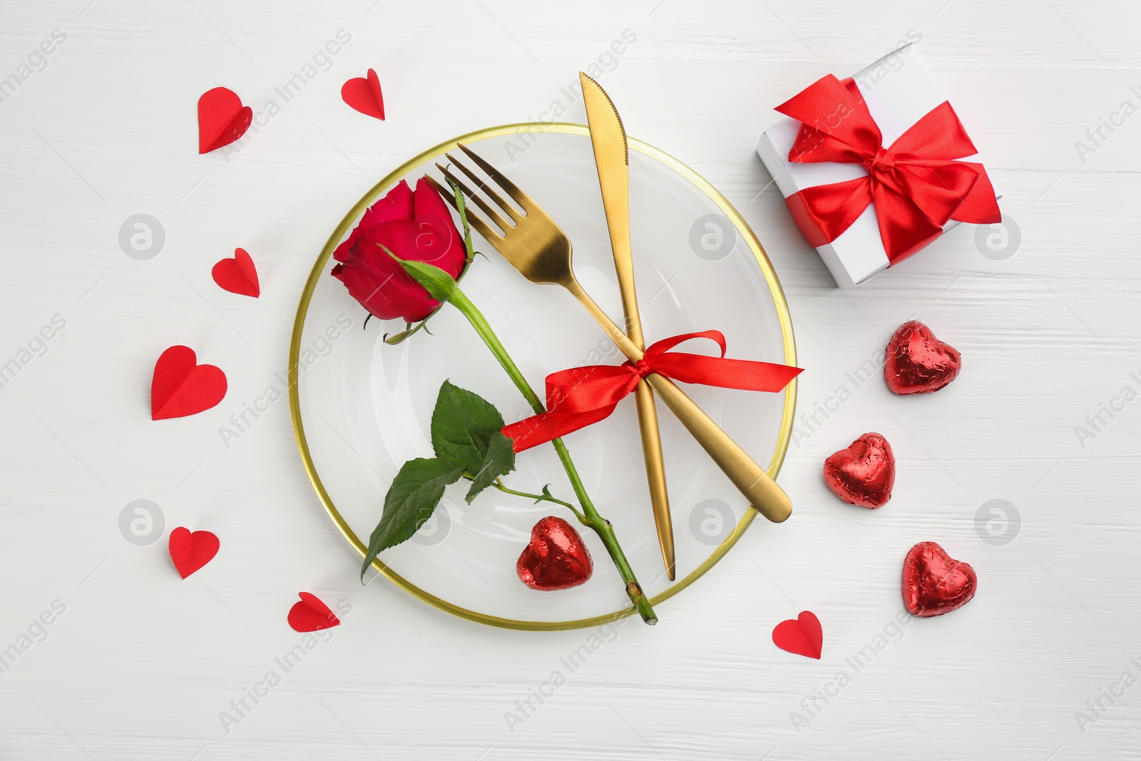 Photo of Beautiful table setting for Valentine's Day dinner on white wooden background, flat lay