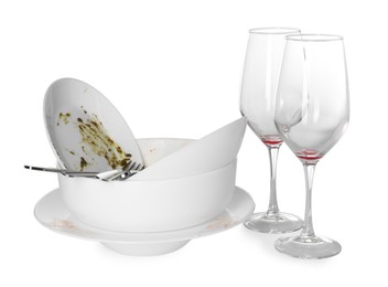 Photo of Many dirty dishes and glasses isolated on white