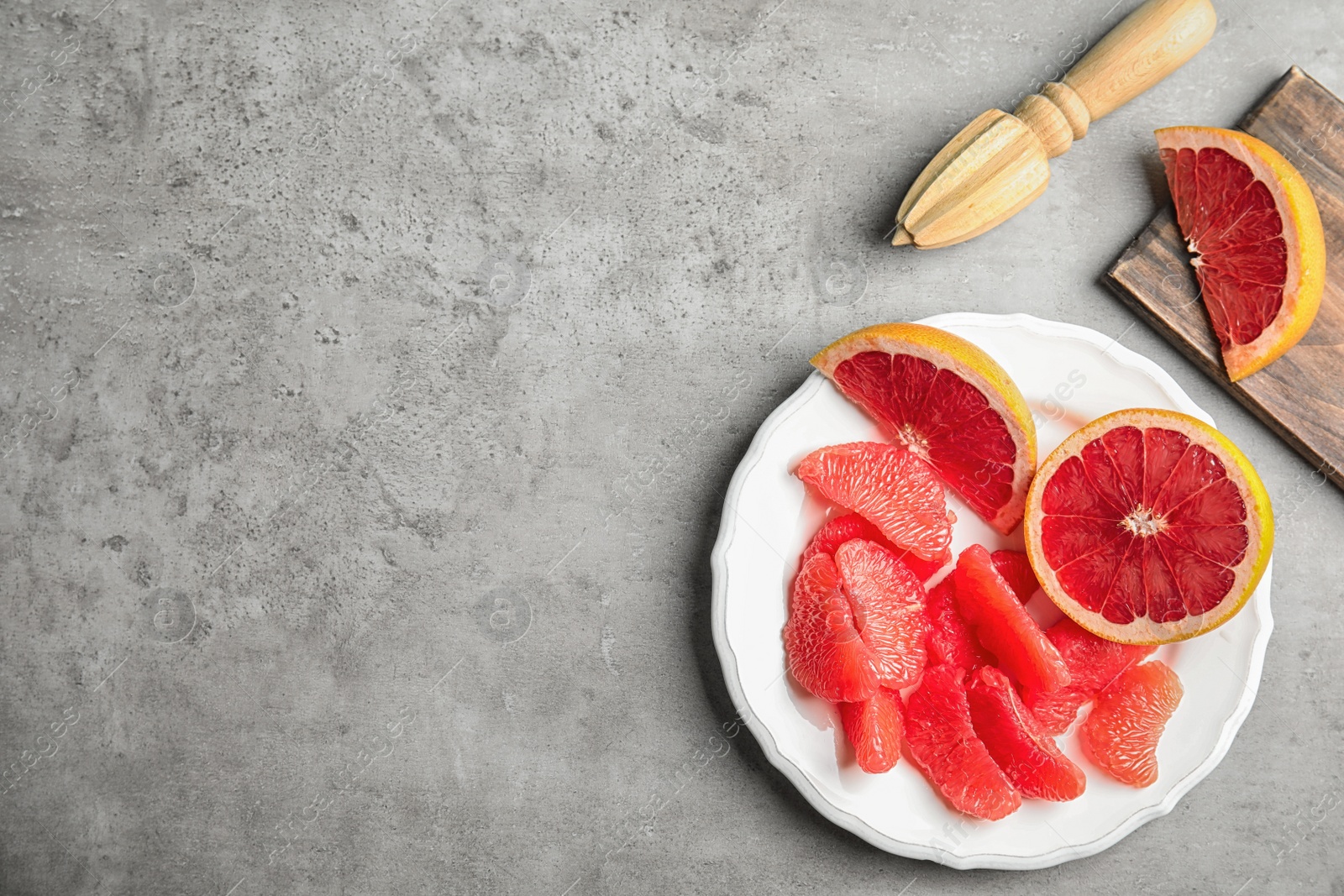 Photo of Flat lay composition with grapefruit and space for text on grey background