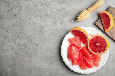 Photo of Flat lay composition with grapefruit and space for text on grey background