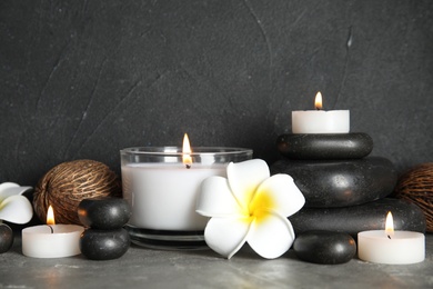 Photo of Spa composition with stones and candles on table