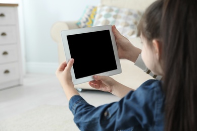 Photo of Mother and her daughter using video chat on tablet at home. Space for text