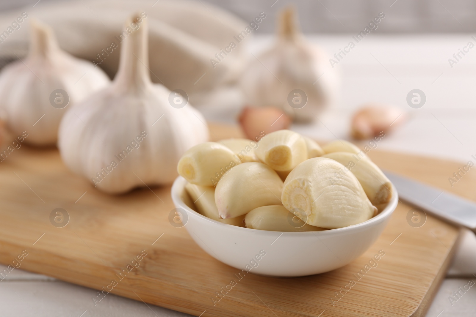 Photo of Fresh garlic on white wooden table, closeup