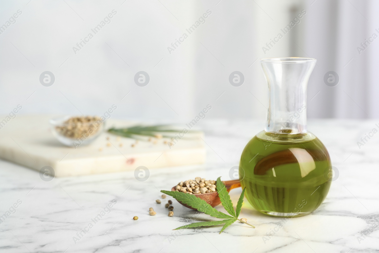 Photo of Composition with hemp oil on marble table. Space for text