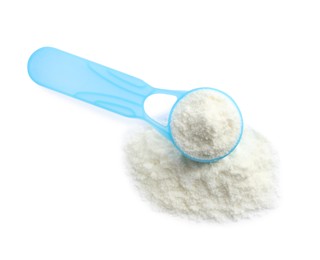 Photo of Powdered infant formula and scoop on white background, top view. Baby milk