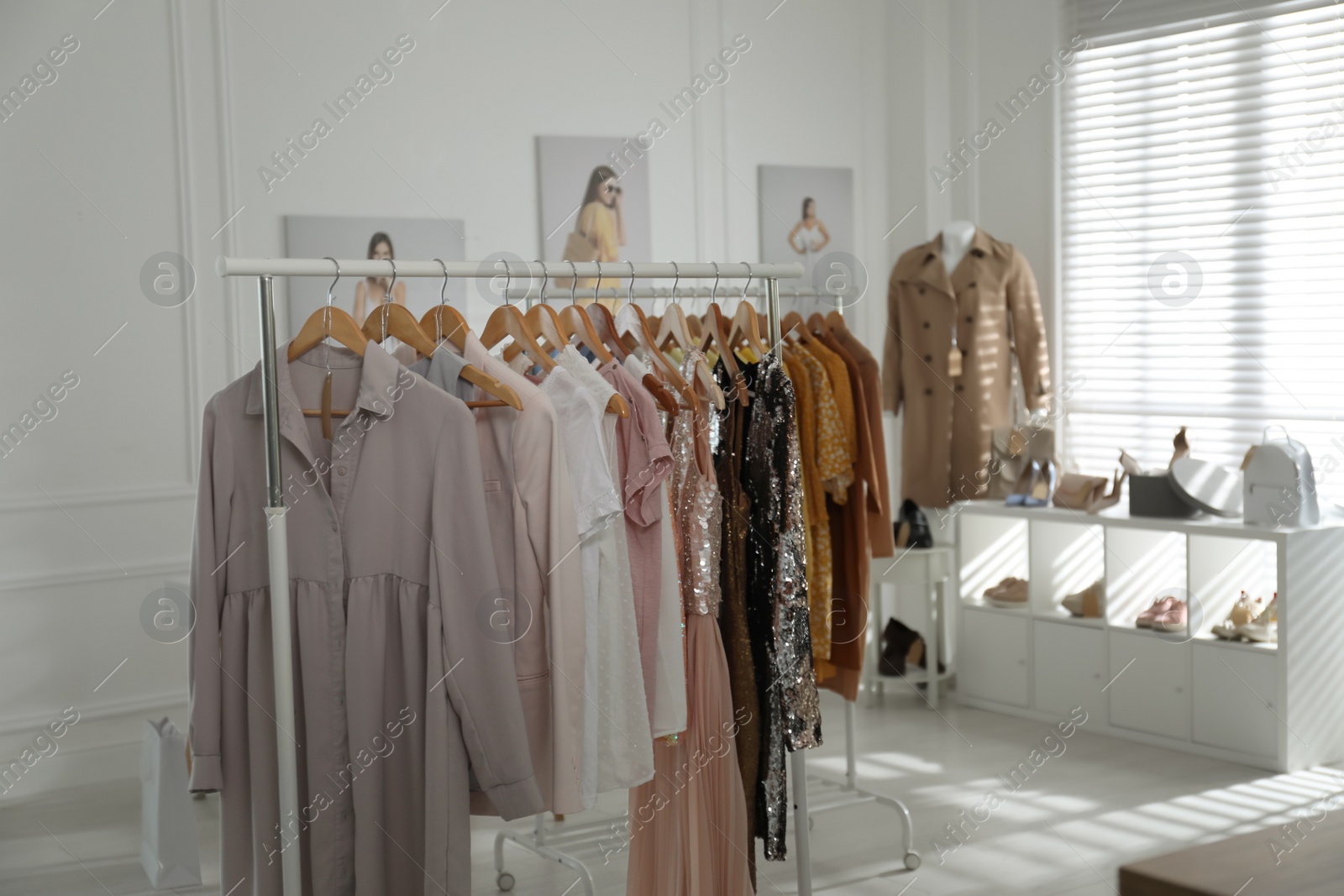 Photo of Collection of stylish women's clothes, shoes and accessories in modern boutique