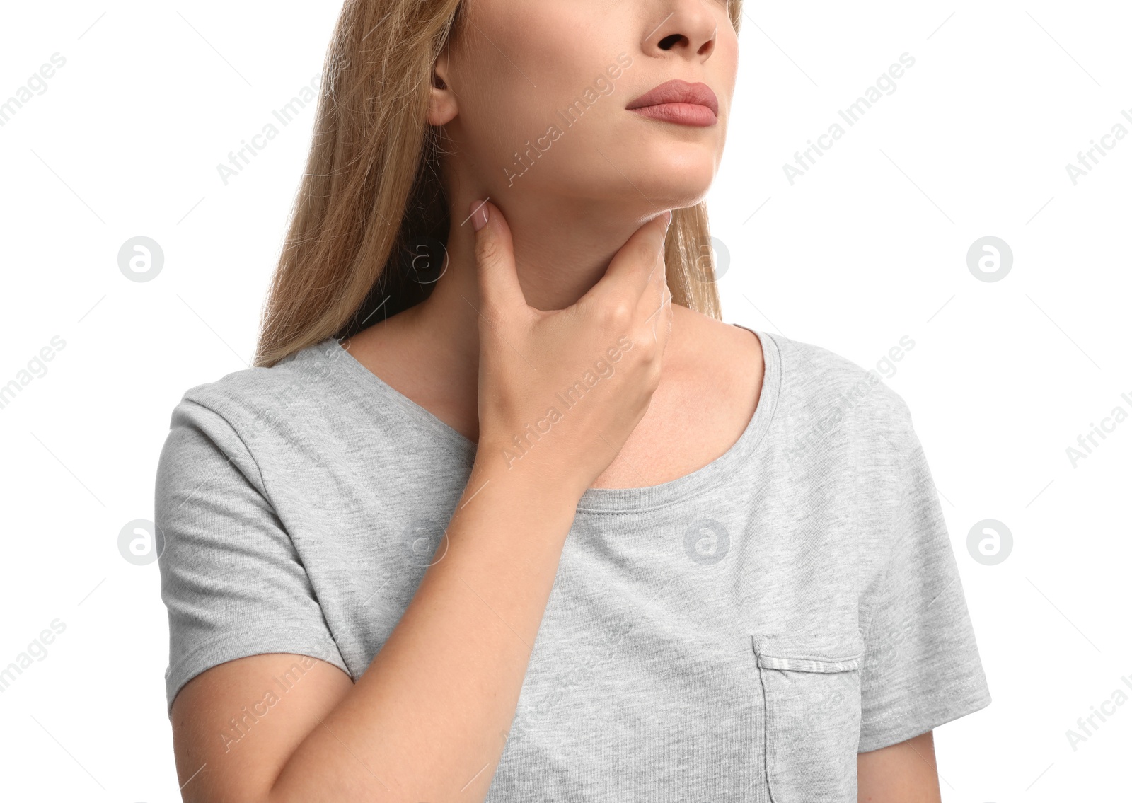 Photo of Young woman doing thyroid self examination on white background, closeup