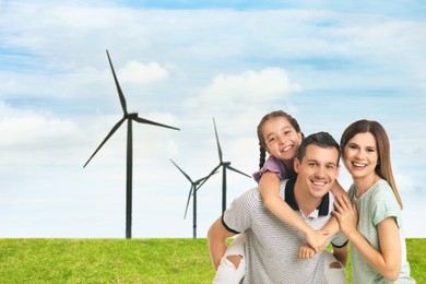 Image of Happy family with child and view of wind energy turbines