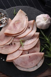 Photo of Tasty ham with rosemary, garlic, sea salt and peppercorns on table, top view