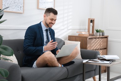 Photo of Businessman in underwear pretending to wear formal clothes during video call at home