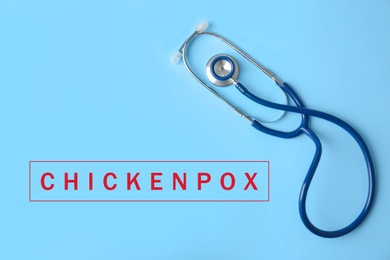 Image of Stethoscope on light blue background, top view. Chickenpox disease 